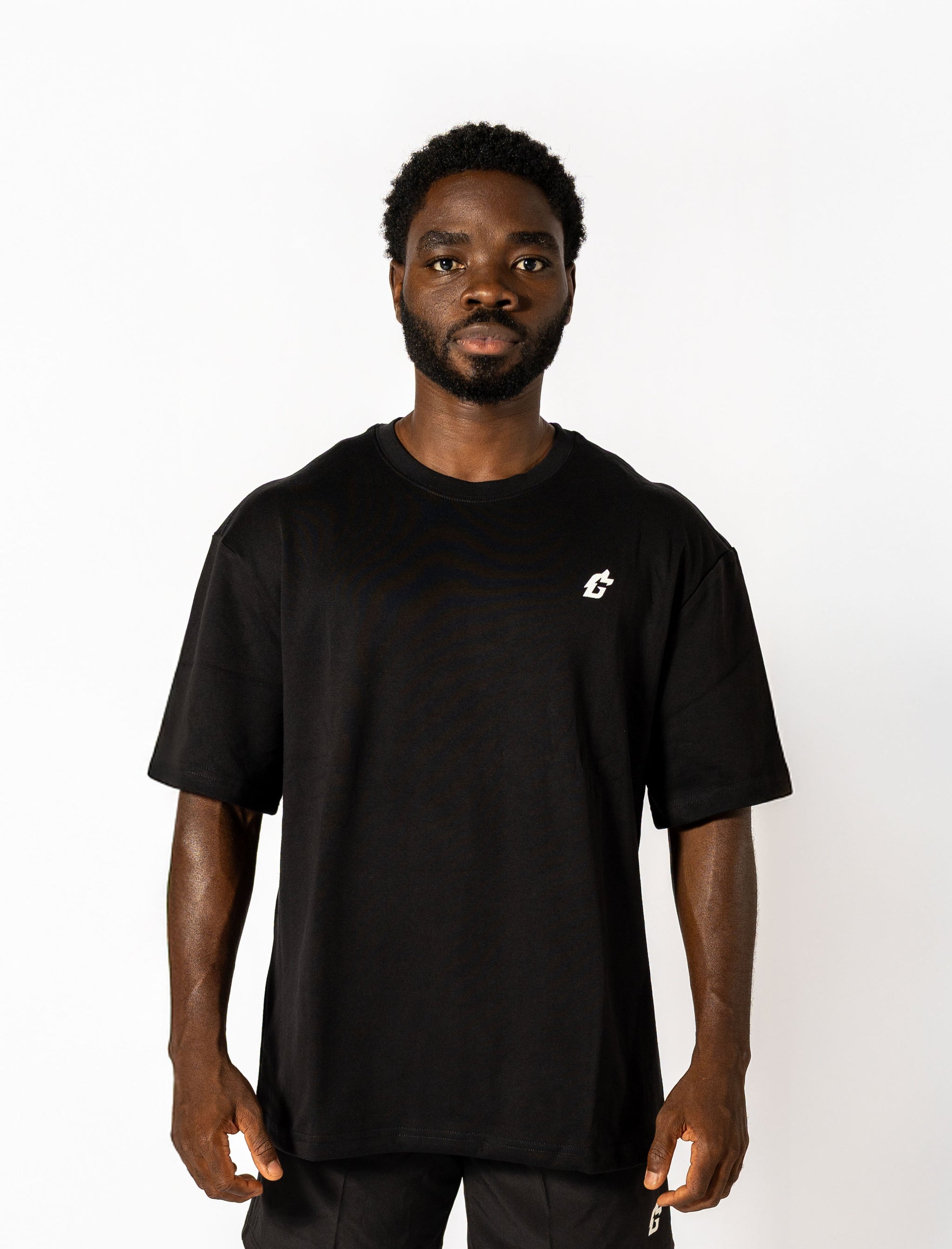  Oversized black tee with white lettering "Conquer Your Demons," perfect for training, layering, or relaxed casual outings.