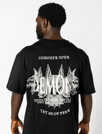  Oversized black tee with white lettering "Conquer Your Demons," perfect for training, layering, or relaxed casual outings.