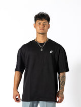 A man dressed in a black shirt that reads "gymryu club," emphasizing strength and performance for dedicated athletes.