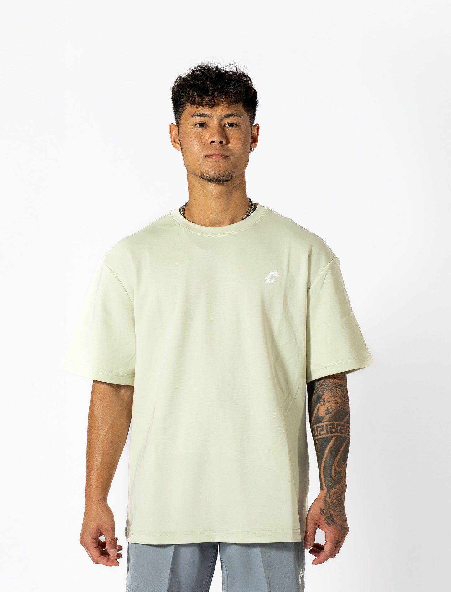  Oversized mint-green tee with white lettering "Conquer Your Demons," perfect for training, layering, or relaxed casual outings.