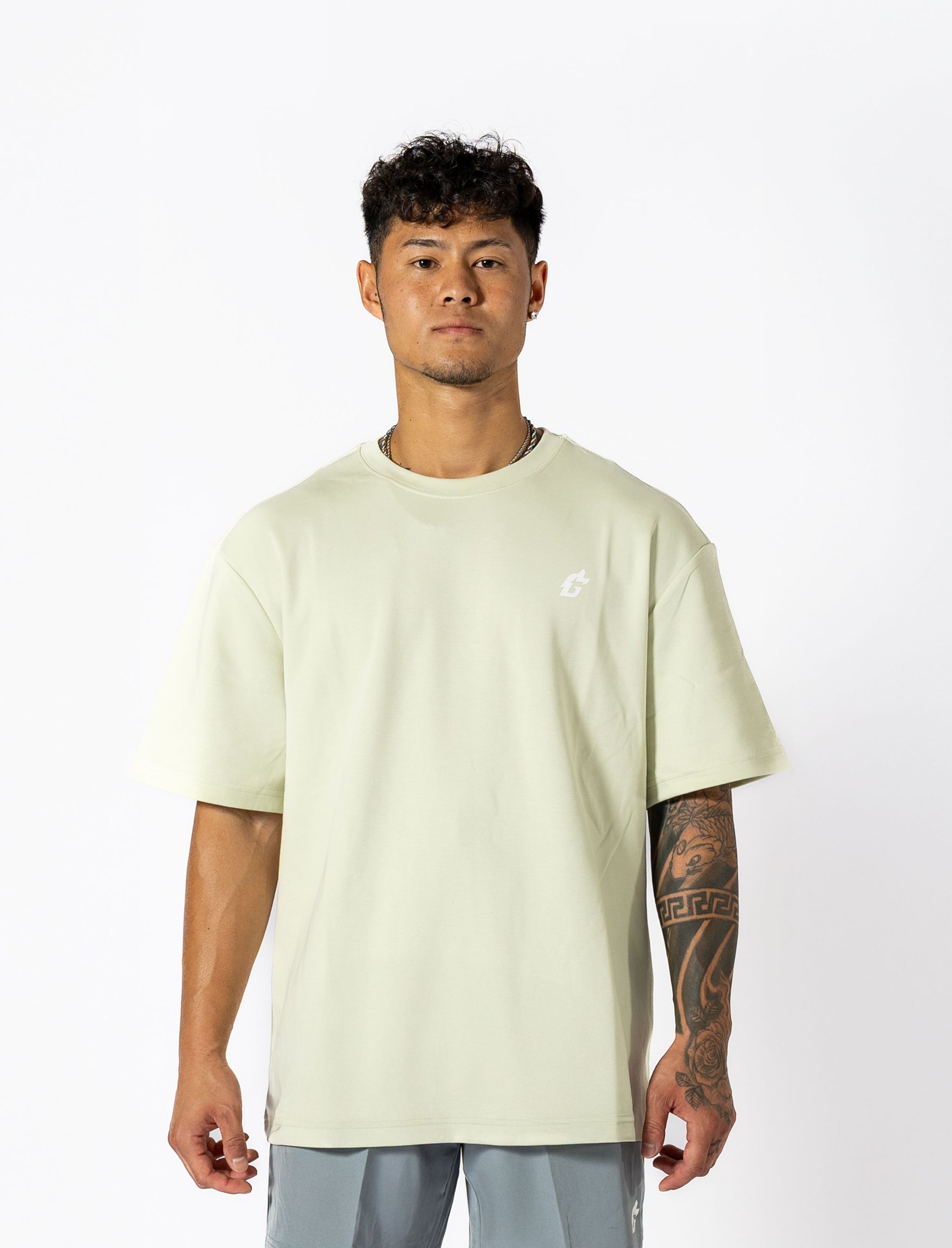  Oversized mint-green tee with white lettering "Conquer Your Demons," perfect for training, layering, or relaxed casual outings.