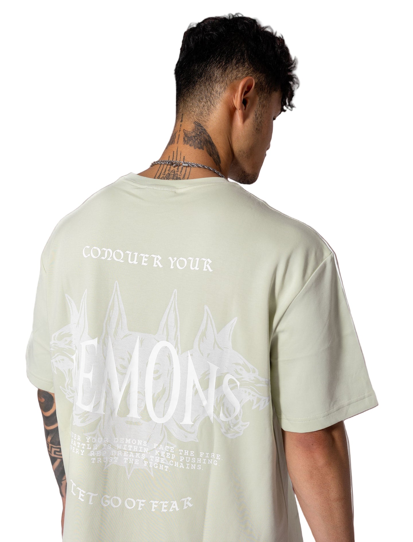 Oversized green-mint tee with white lettering "Conquer Your Demons," perfect for training, layering, or relaxed casual outings.