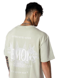 Oversized green-mint tee with white lettering "Conquer Your Demons," perfect for training, layering, or relaxed casual outings.