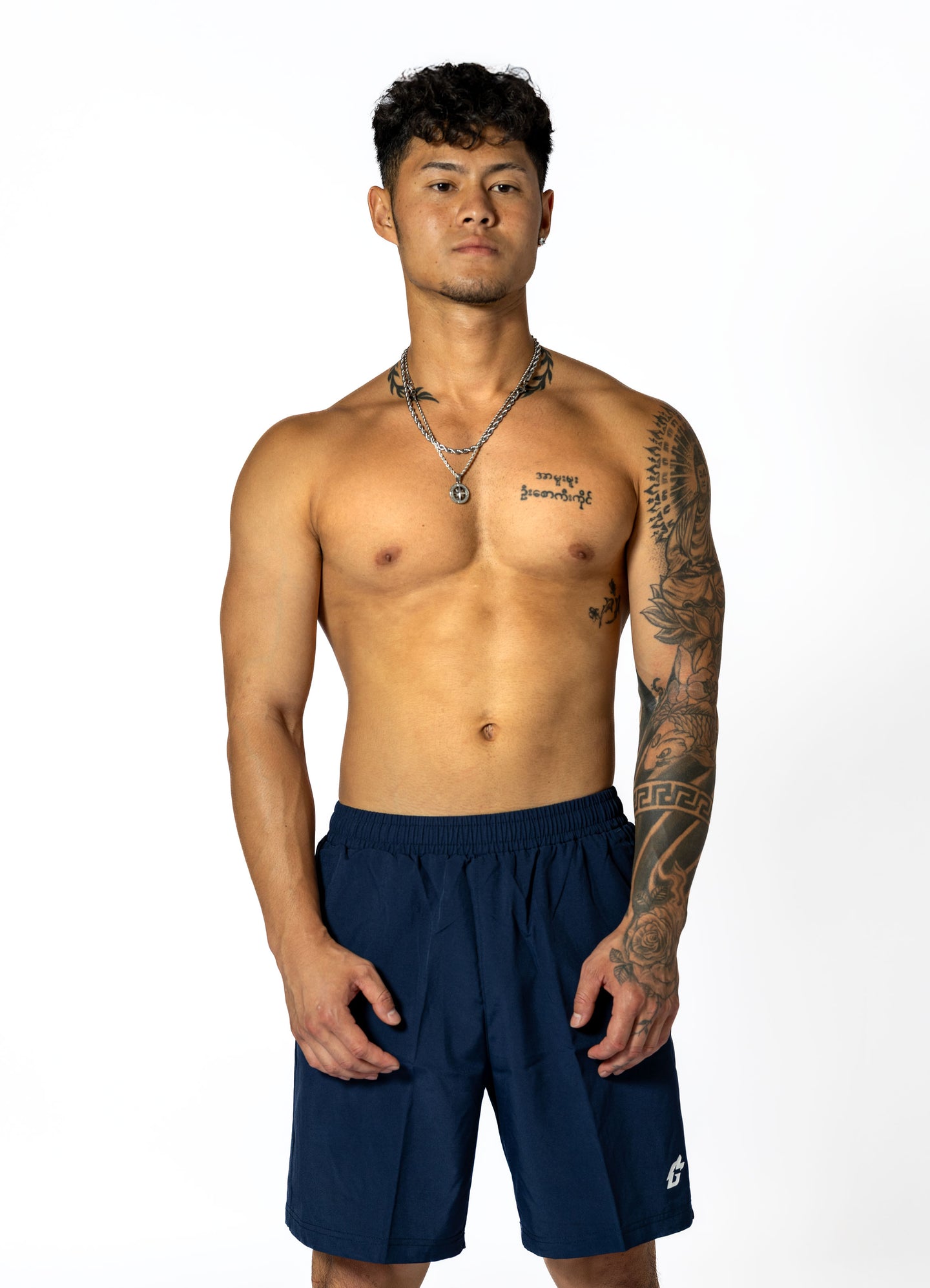 A man wearing navy blue shorts, showcasing durable, moisture-wicking gym wear designed for optimal performance.