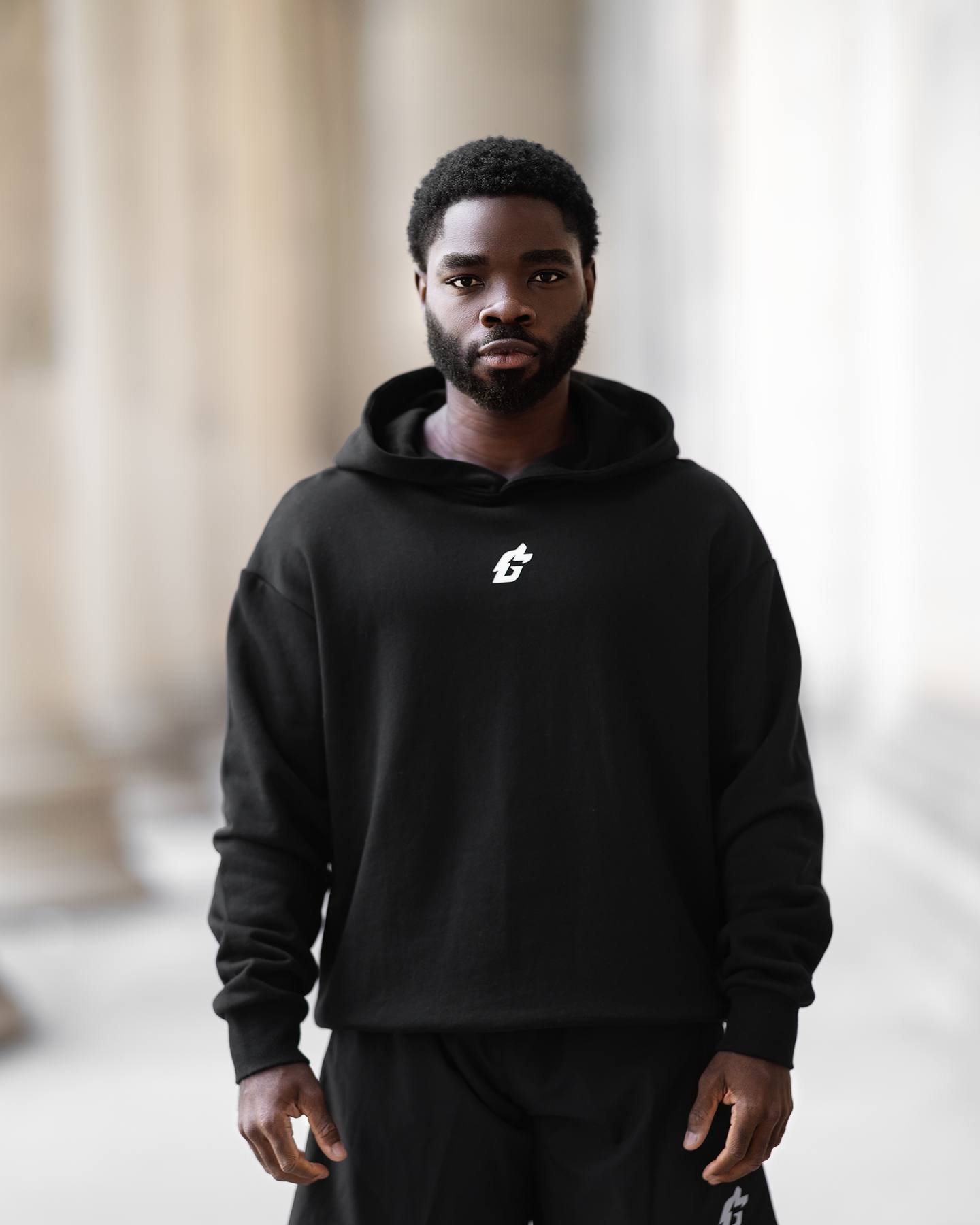 A man in a black hoodie featuring a leopard print, showcasing a stylish and relaxed fit designed for winter activities.